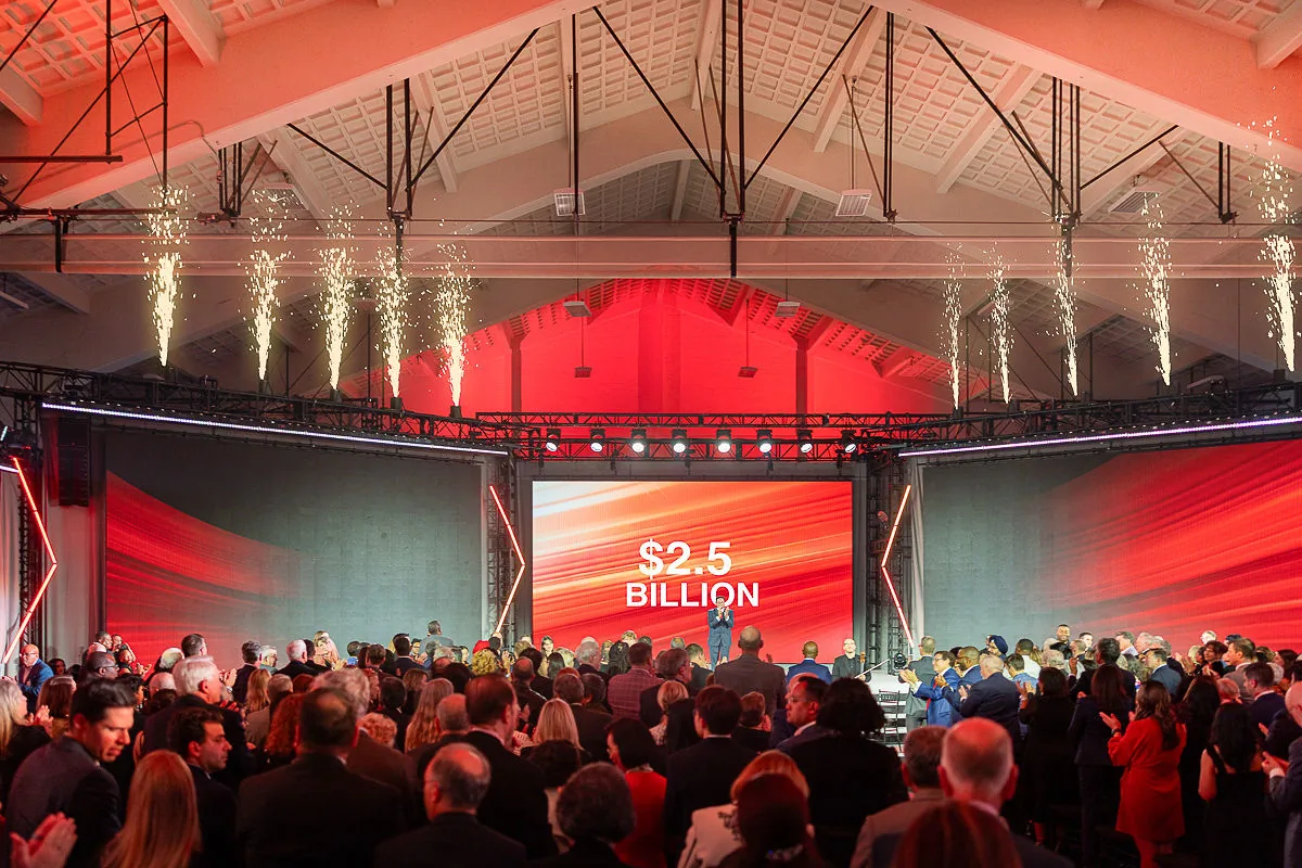 Large corporate fundraising gala stage in Washington DC with LED screen, keynote area, and professional production lighting