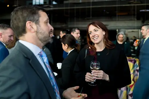 Guests networking at a Washington DC corporate event reception with drinks and conversation