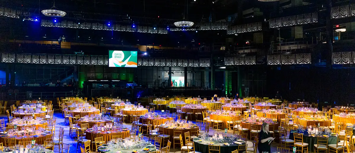 Large corporate gala setup at The Anthem in Washington DC with banquet tables, stage lighting, and event production