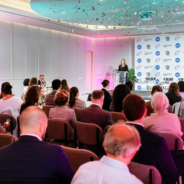 Speaker presenting at a press conference with audience seated in a conference room in Washington DC