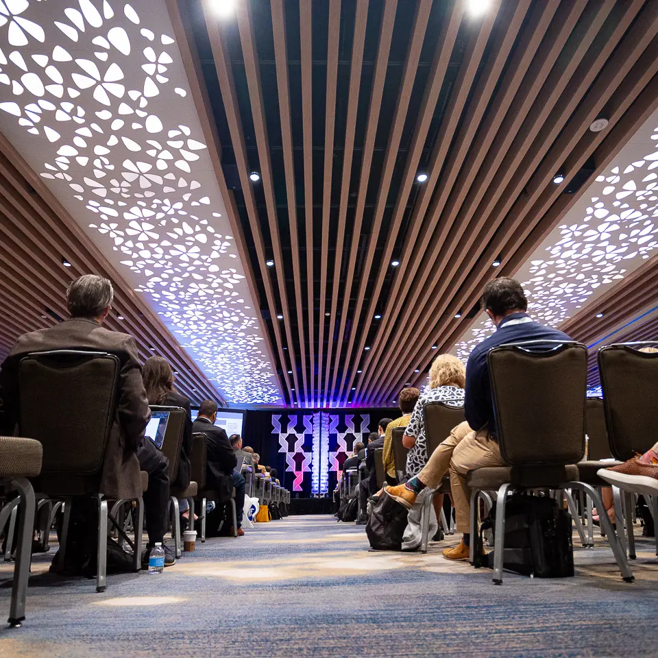 Low-angle view of FDA-PDA Annual Conference panelists on stage with audience seating