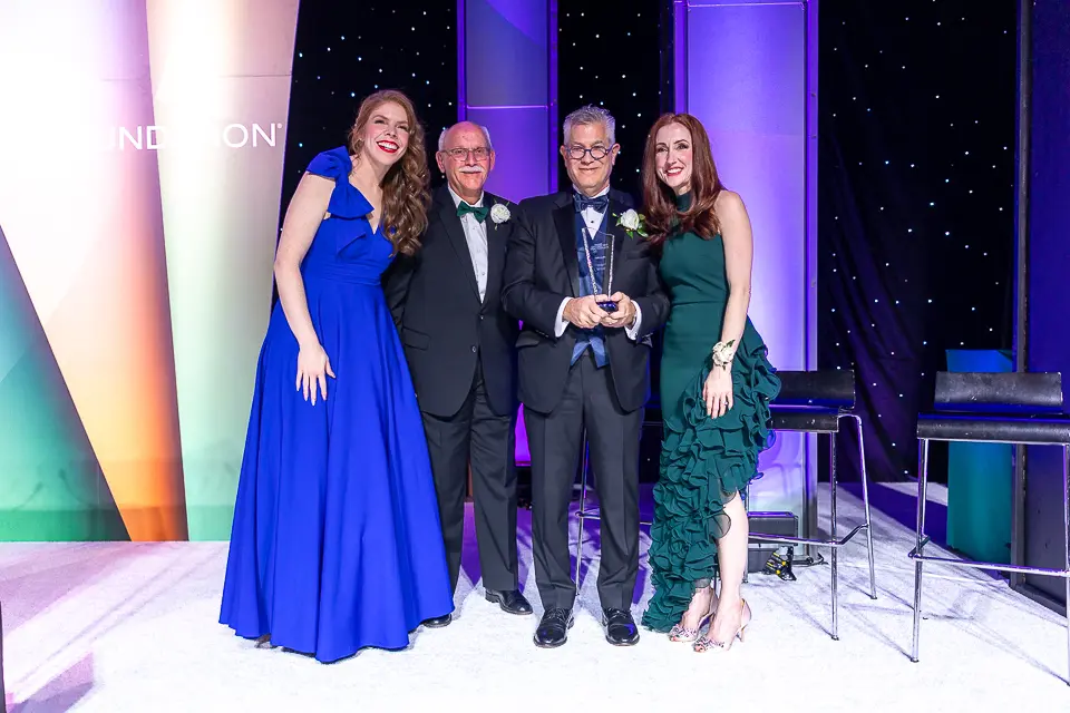 Honoree and family portrait on the Herb Wegner Awards 2026 stage.