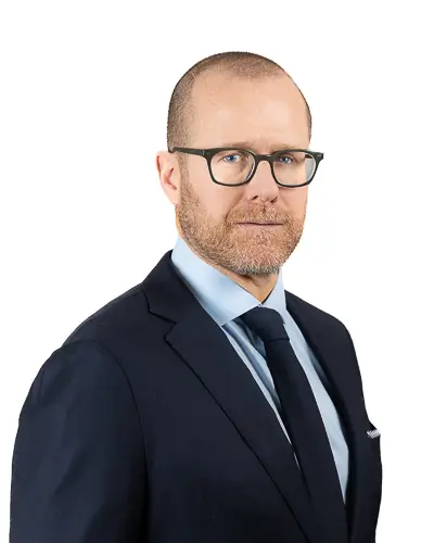 Professional business headshot of man in blue blazer and navy sweater photographed in Washington DC by District Pixel
