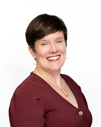 Professional business headshot of woman in burgundy top photographed in Washington DC by District Pixel