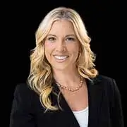Washington DC executive headshot of a smiling female professional in a black suit, photographed by District Pixel.